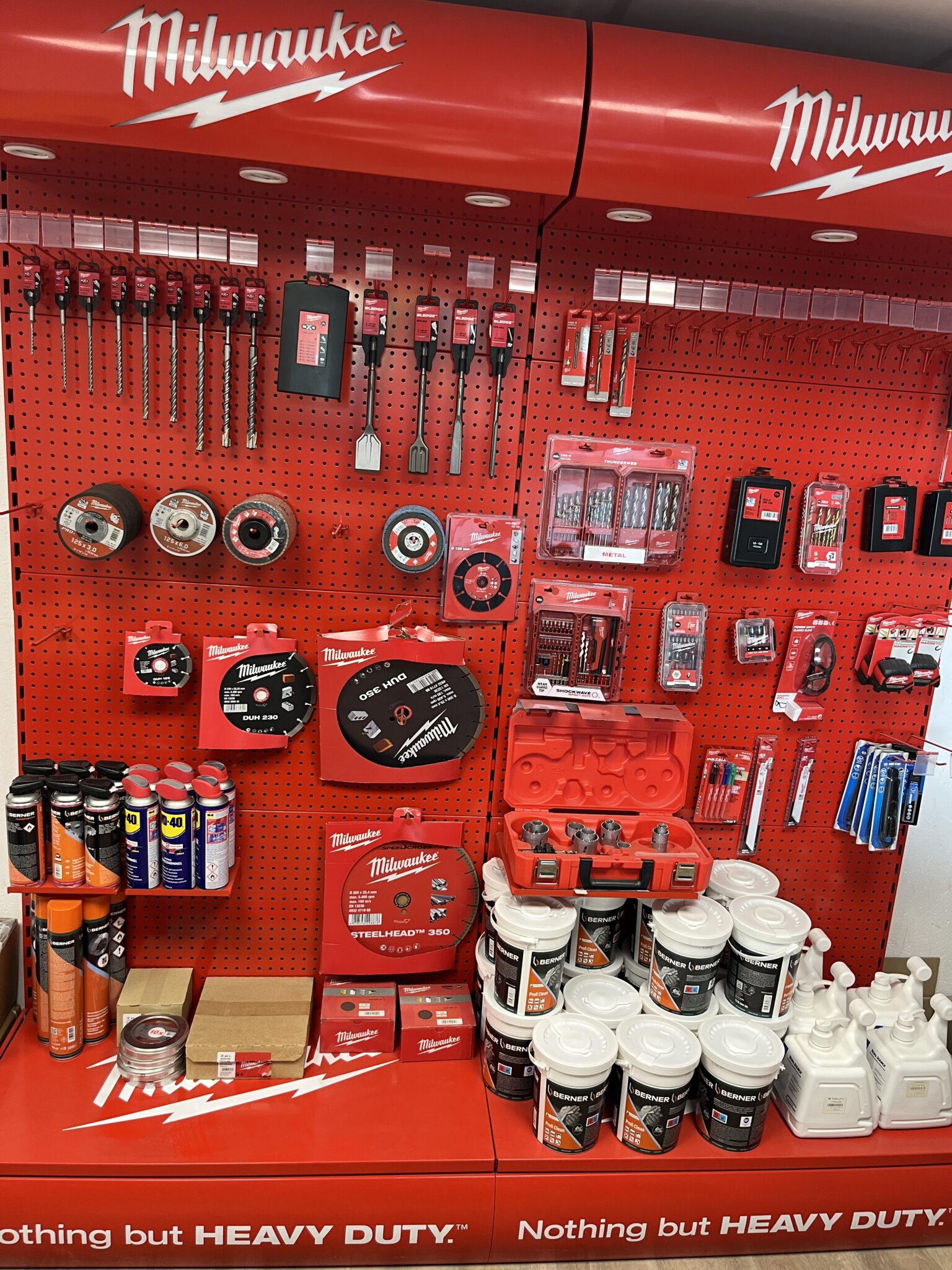 Outils et accessoires Milwaukee en exposition murale rouge.